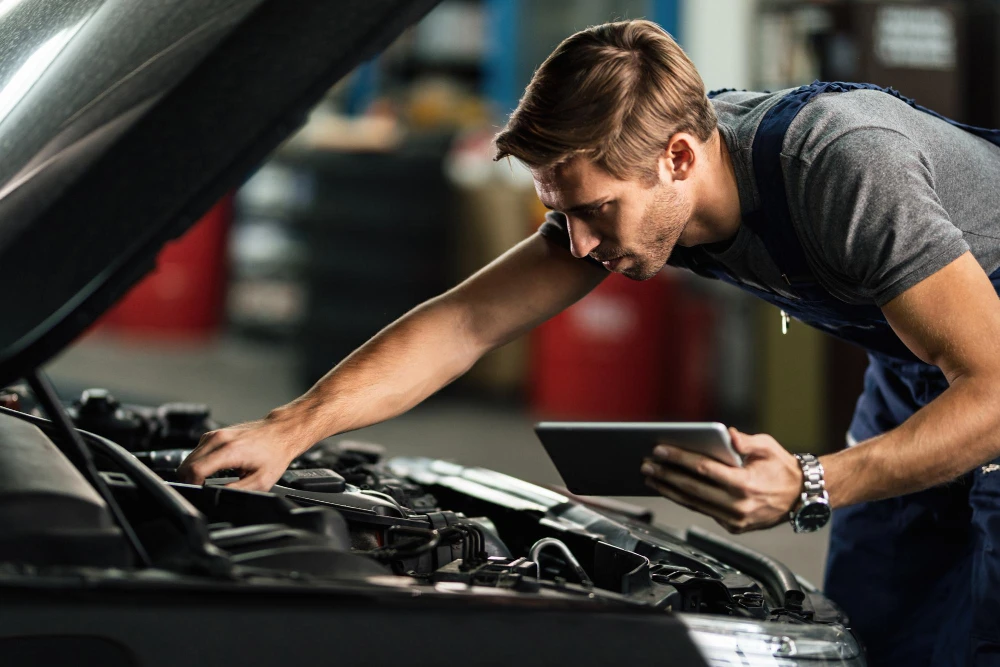 Professional automotive technician using diagnostic equipment